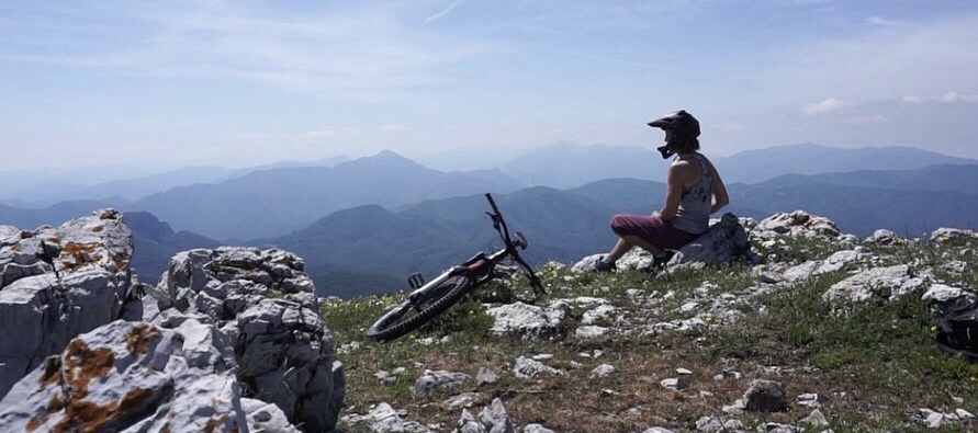 Maastopyöräilijä vuoren huipulla